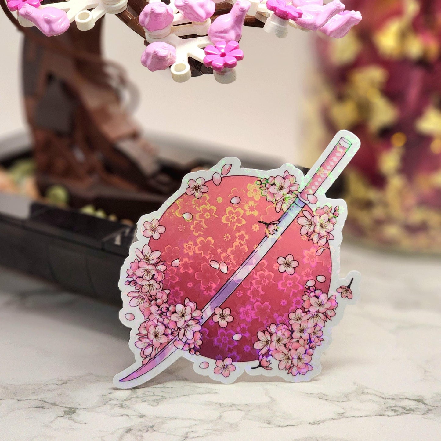 Decorative sticker with floral design and sword on a marble surface
